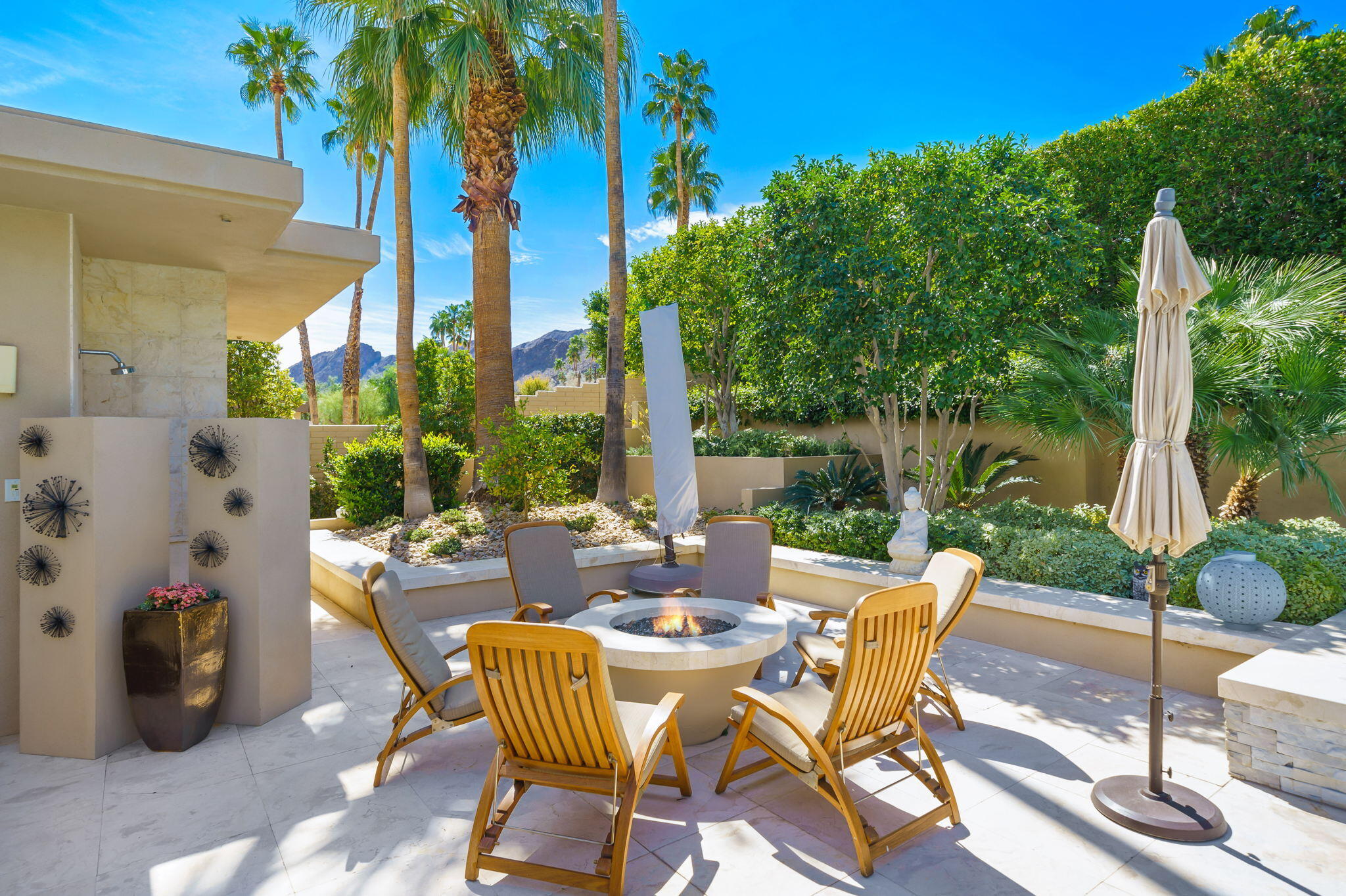 70345 Placerville Road Rancho Mirage, CA 92270 - Photo 112 of 116 a view of a patio with table and chairs potted plants and palm tree