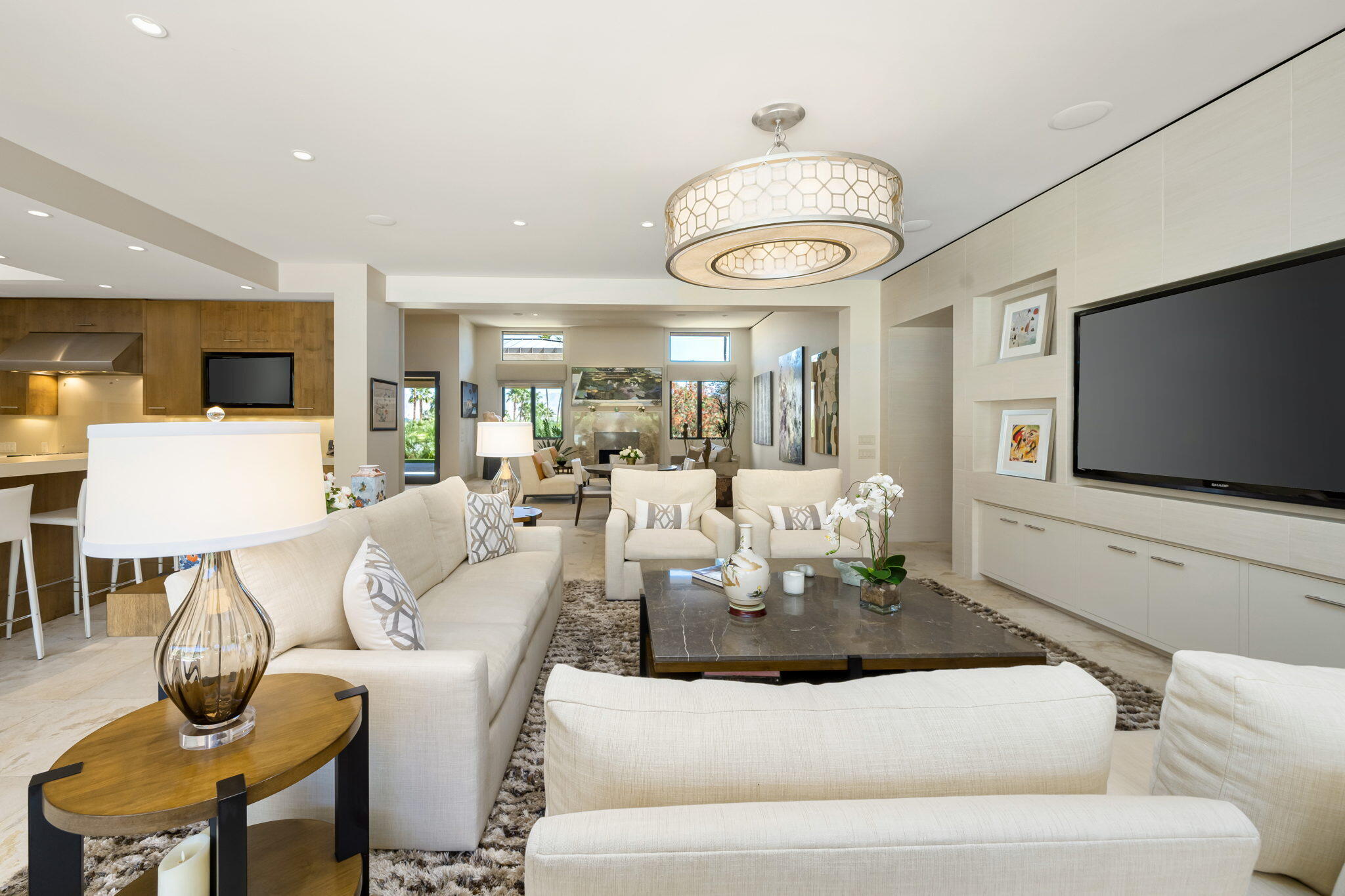 70345 Placerville Road Rancho Mirage, CA 92270 - Photo 26 of 116 a living room with furniture a flat screen tv and kitchen view