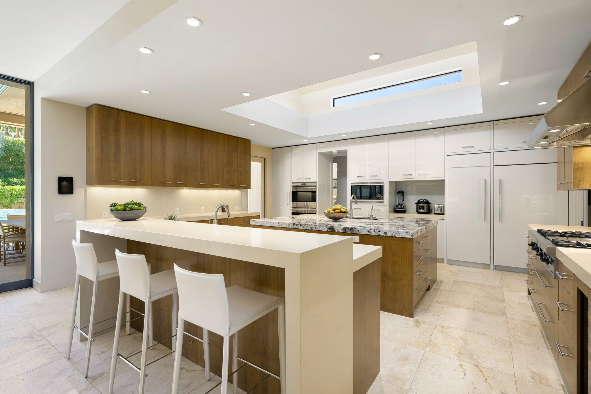 70345 Placerville Road Rancho Mirage, CA 92270 - Photo 30 of 116 a kitchen with lots of counter top space and appliances