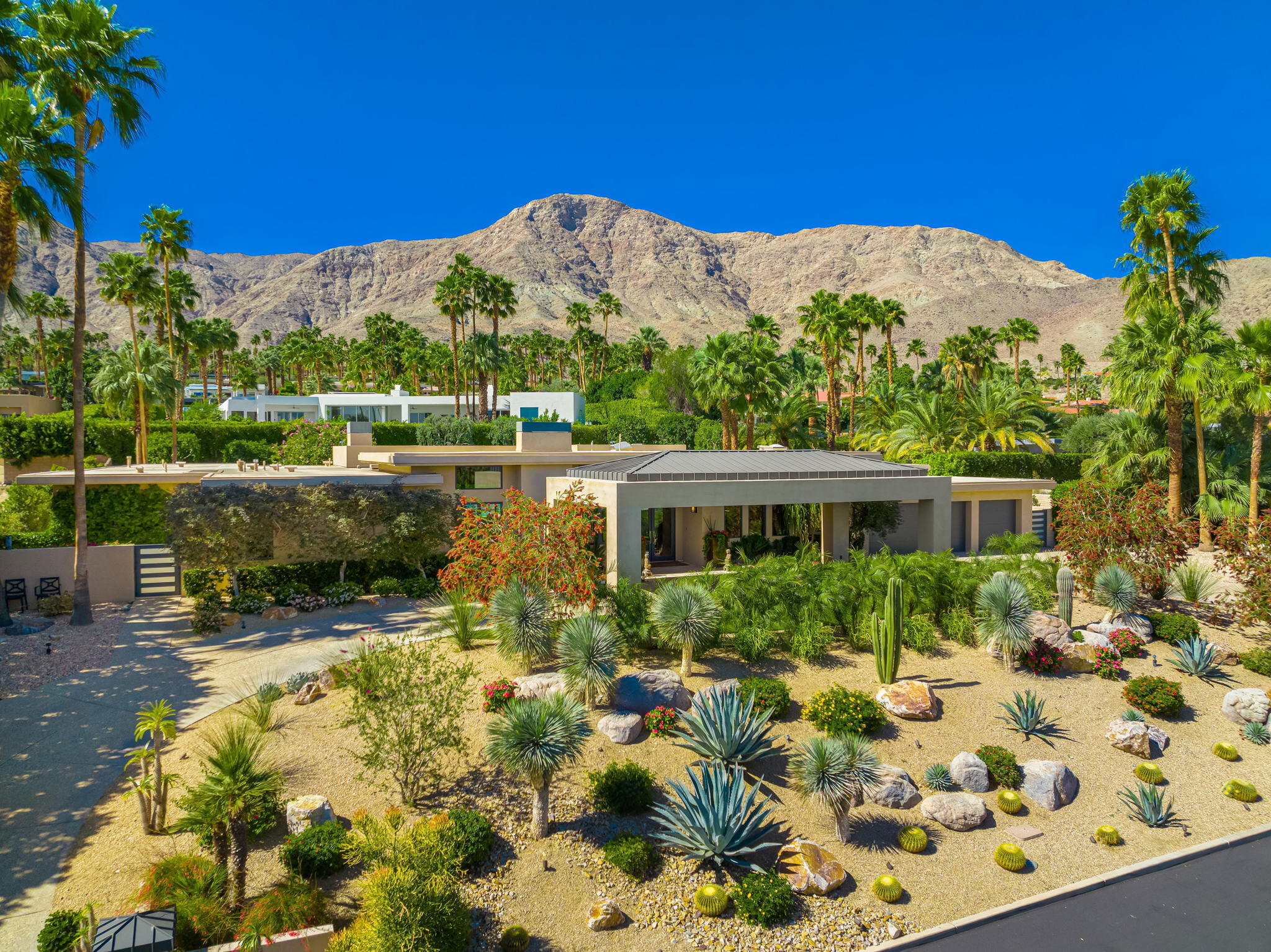 70345 Placerville Road Rancho Mirage, CA 92270 - Photo 10 of 116 a view of a garden with a house in the background