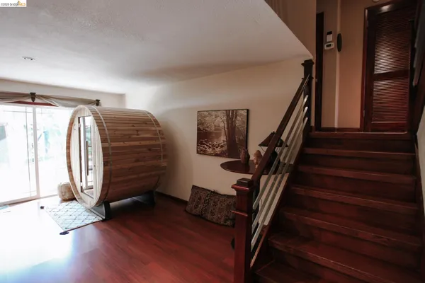a view of entryway with wooden floor and stairs