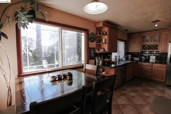 a kitchen with stainless steel appliances granite countertop sink stove and cabinets