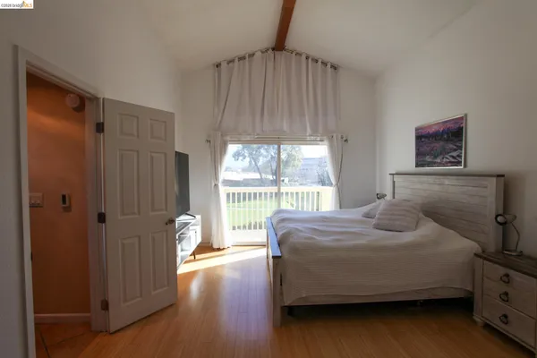 a bedroom with a bed and a large window