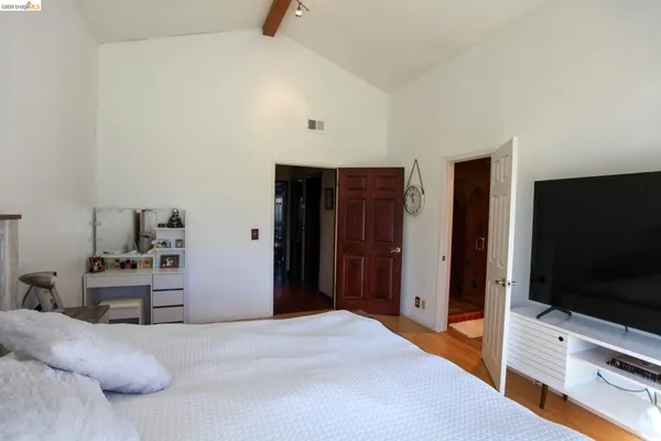 a bedroom with a bed and a flat screen tv