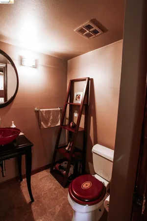 a bathroom with a toilet and a mirror