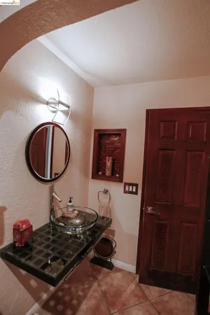 a room with furniture a mirror and wooden walls