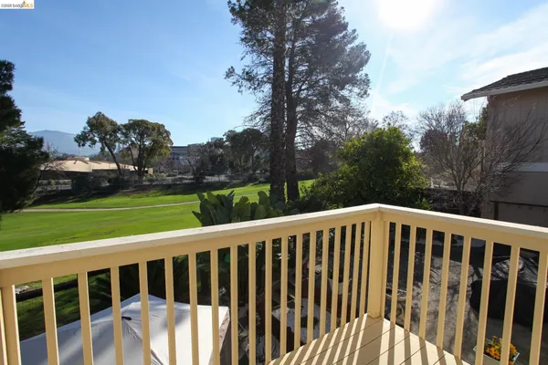 a view of a chair and table on the green field