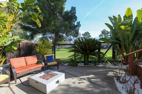 a view of a backyard with sitting area