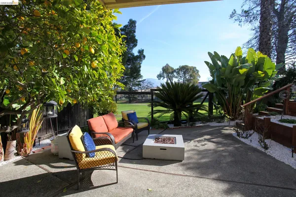 a backyard of a house with table and chairs