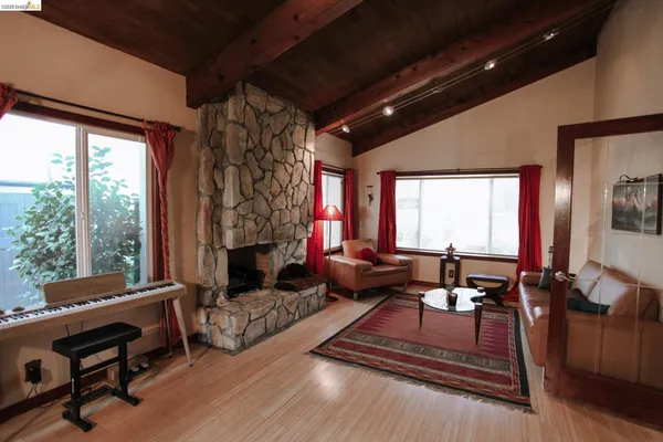 a living room with furniture fireplace and a large window