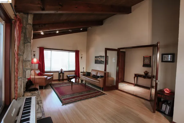 a living room with furniture and wooden floor