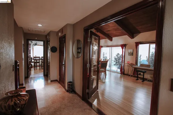 a hallway with wooden floor and furniture