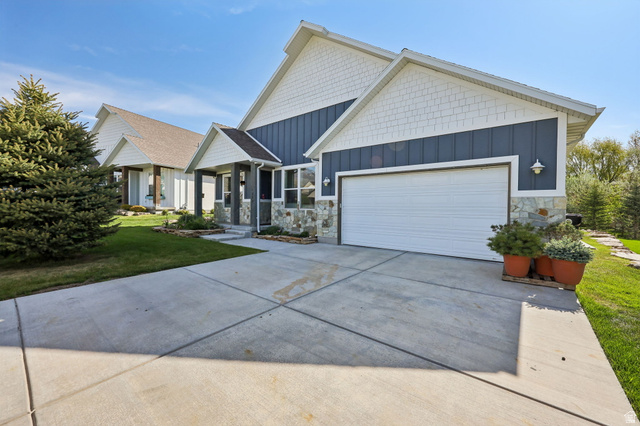 1238 Canyon View Road Midway, UT 84049 - Photo 2 of 36 Contemporary exterior featuring a two-car garage, stone accents, shingle siding, a covered entry, and a concrete driveway
