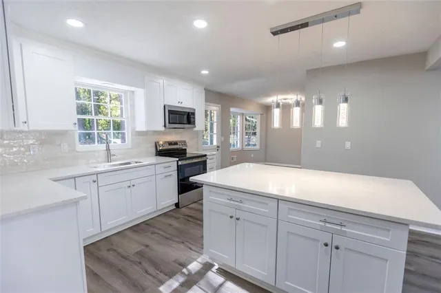 a kitchen with a sink microwave and window