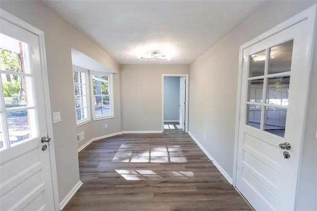 wooden floor in an empty room with a window