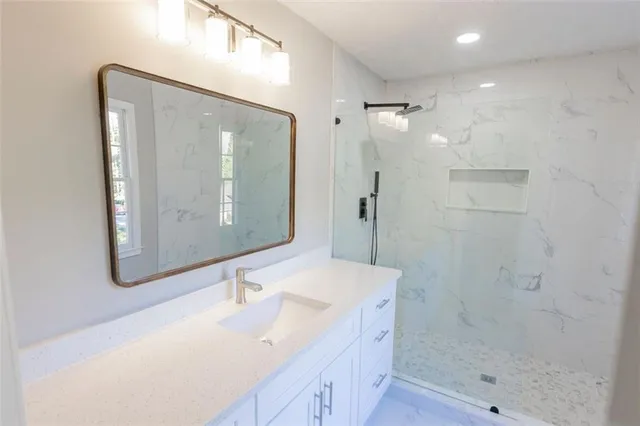a bathroom with a bathtub a sink and a mirror