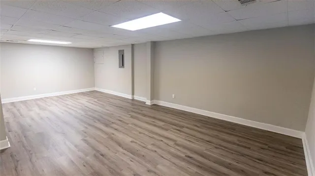 a view of an empty room with wooden floor