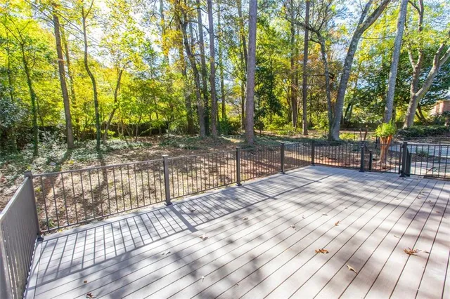 a view of outdoor space with deck and trees