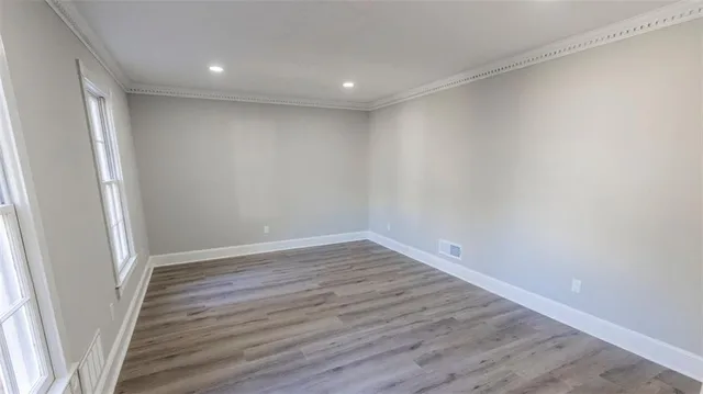 a view of wooden floor and windows in a room