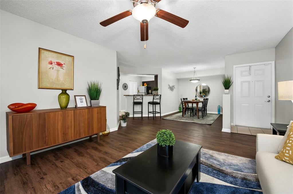10101 Southwest 14th Street, Unit 3B10108 Pembroke Pines, FL 33025 - Photo 16 of 48 a living room with furniture and a wooden floor