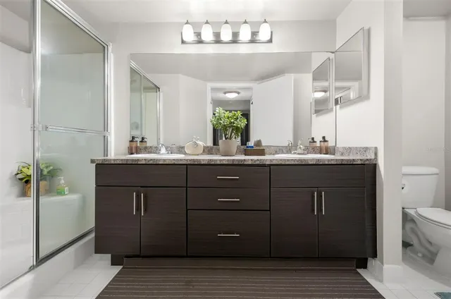 a bathroom with a sink vanity granite and a mirror