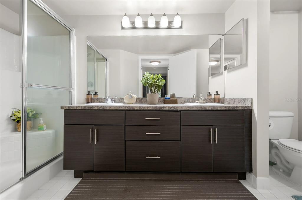 10101 Southwest 14th Street, Unit 3B10108 Pembroke Pines, FL 33025 - Photo 20 of 48 a bathroom with a sink vanity granite and a mirror