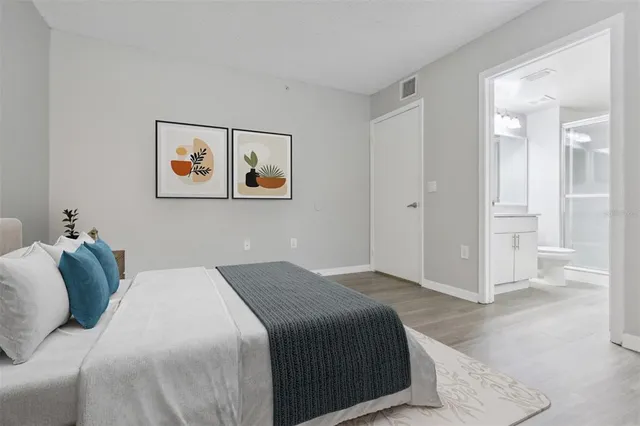 a bedroom with a bed and wall painting