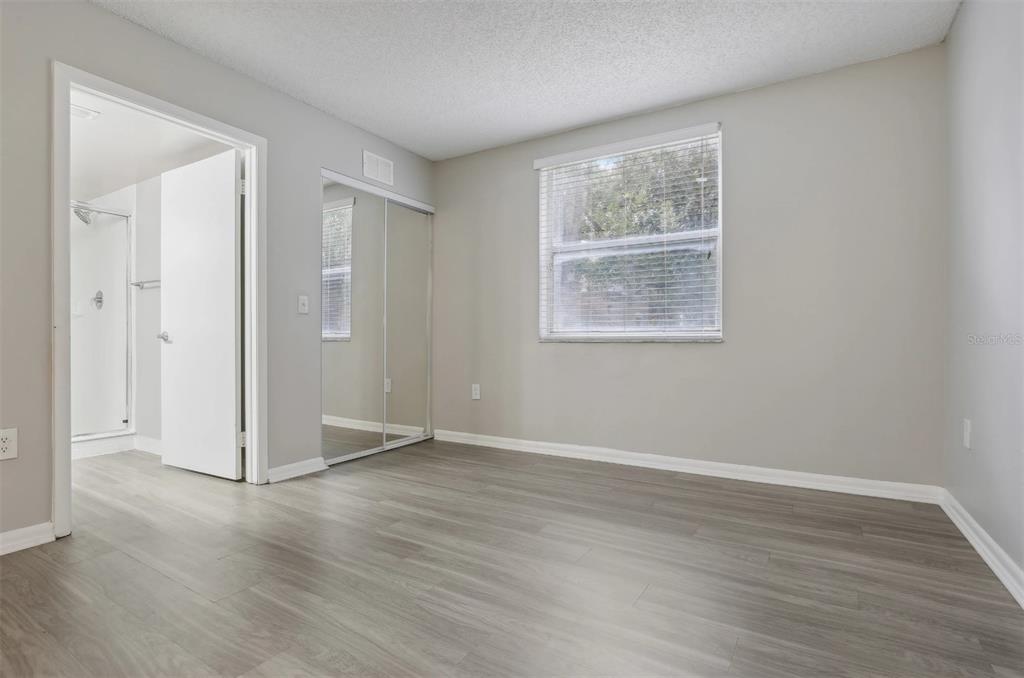 10101 Southwest 14th Street, Unit 3B10108 Pembroke Pines, FL 33025 - Photo 43 of 48 an empty room with wooden floor and windows