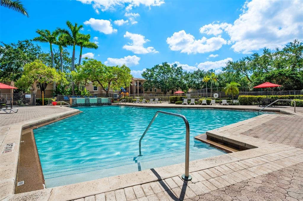 10101 Southwest 14th Street, Unit 3B10108 Pembroke Pines, FL 33025 - Photo 9 of 48 a view of a swimming pool with a patio