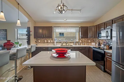 a kitchen with a sink appliances and cabinets