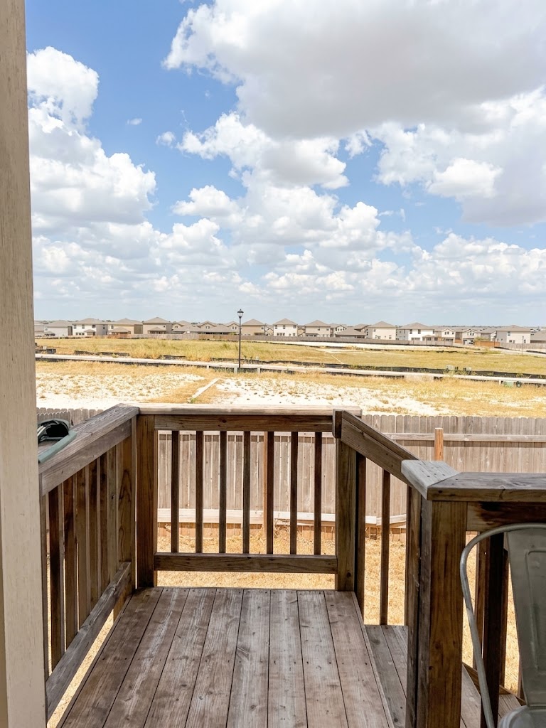 225 Comancheros Road Jarrell, TX 76537 - Photo 16 of 21 Elevated wooden decking provides open neighborhood views under a spacious sky.