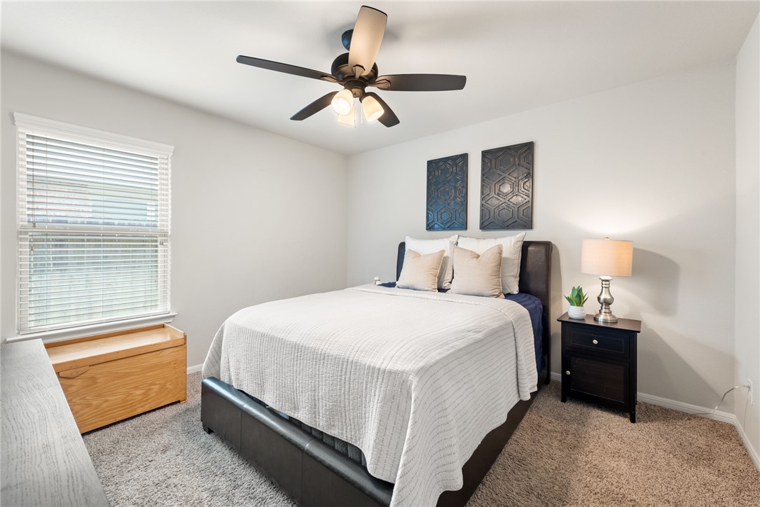 2018 Eagle View Drive Navasota, TX 77868 - Photo 19 of 28 a bedroom with a bed and a chandelier