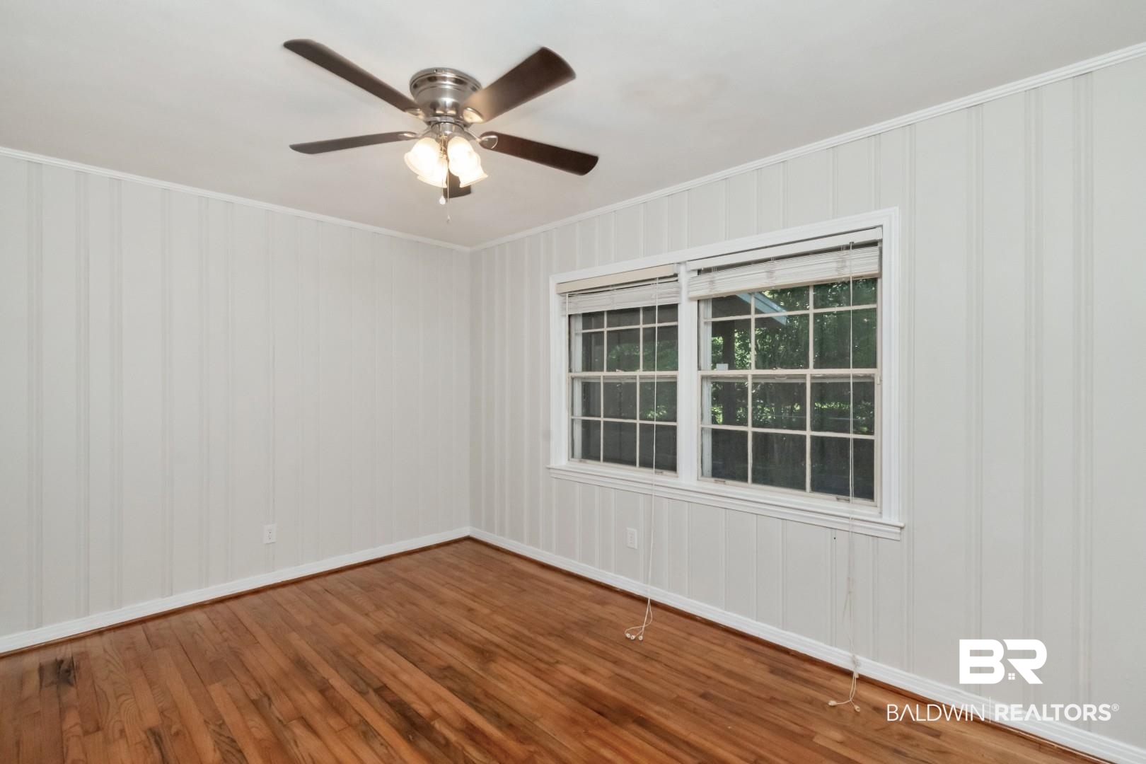 2105 Upham Court Mobile, AL 36607 - Photo 18 of 32 Unfurnished room with ornamental molding, wood finished floors, and a ceiling fan