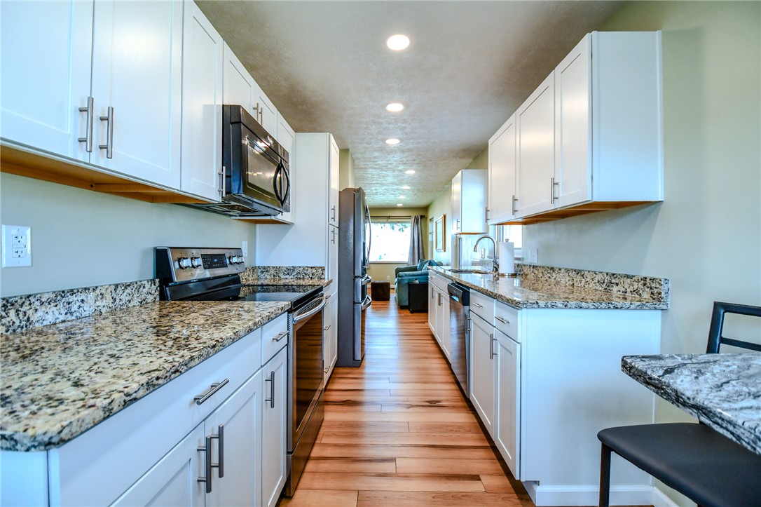816 South Smithville Road Dayton, OH 45403 - Photo 13 of 33 This galley kitchen features durable wood flooring and elegant granite counters for a clean aesthetic.