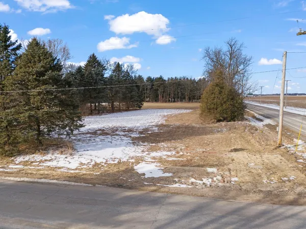 a view of a yard with wooden fence