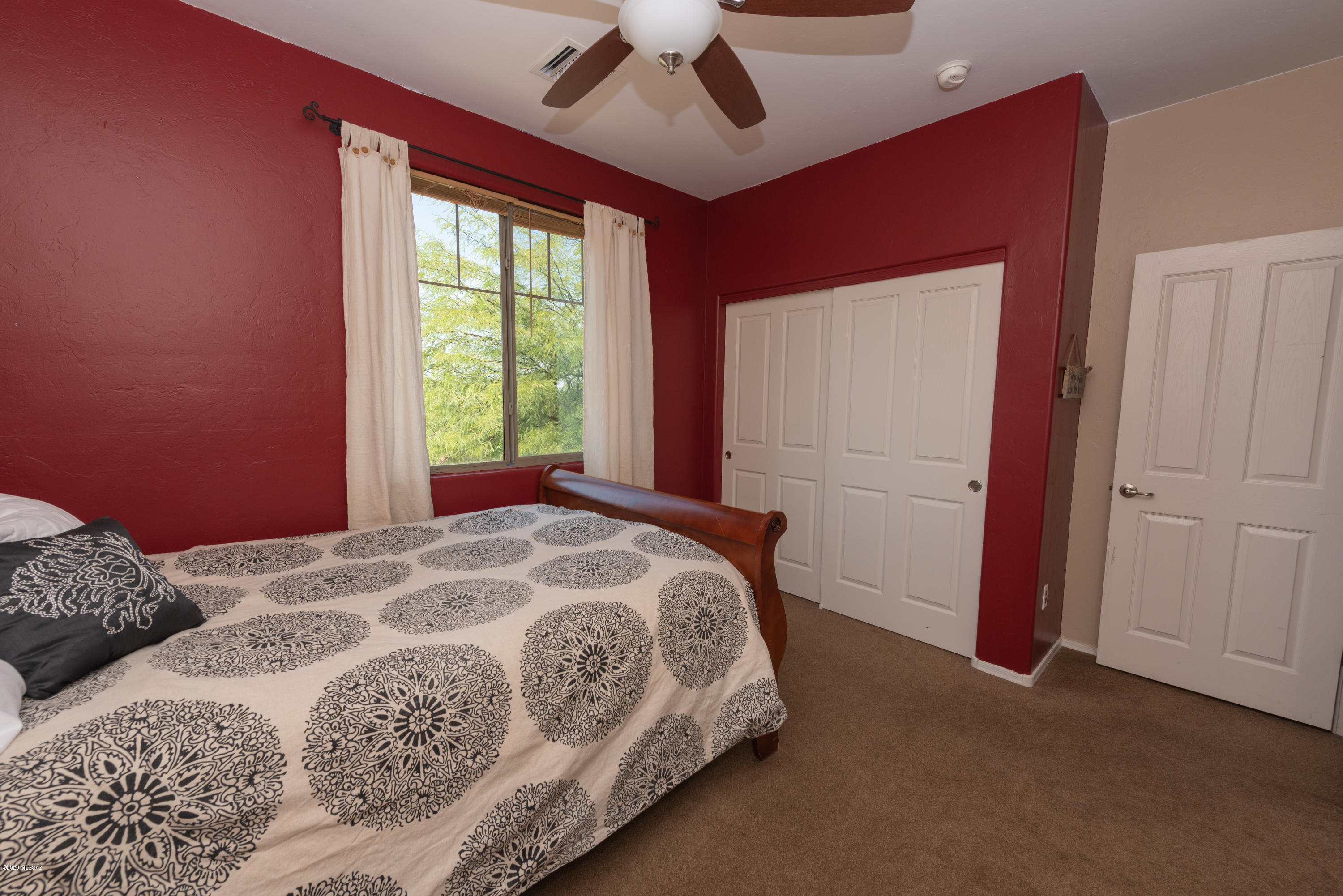 12910 Bloomington Loop Oro Valley, AZ 85755 - Photo 27 of 30 a bedroom with a bed and a large window