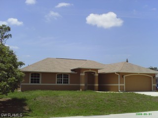 8342 Cardinal Road Fort Myers, FL 33967 - Photo 1 of 7 a view of a yard in front of a house with plants and large tree