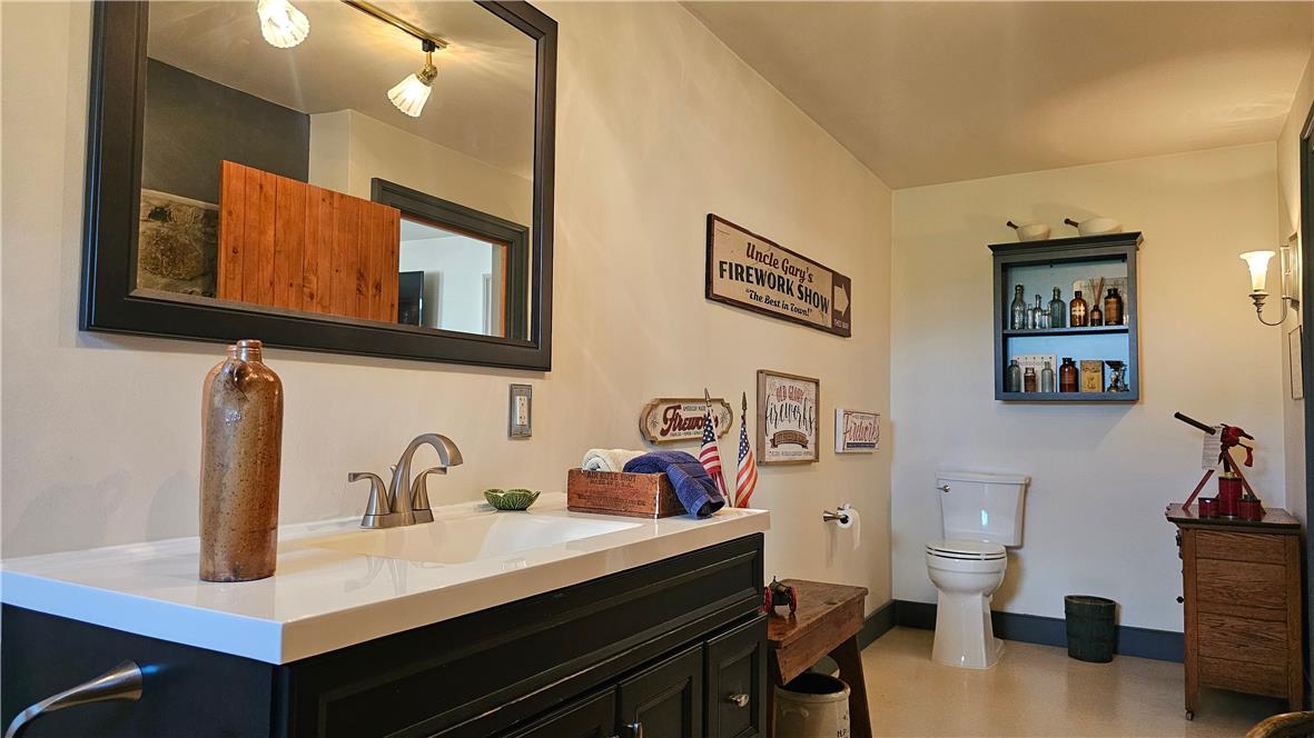 585 Buttermilk Road Hellertown, PA 18055 - Photo 22 of 82 Well-appointed bathroom showcasing a pristine vanity with a sleek countertop and a spacious mirror.