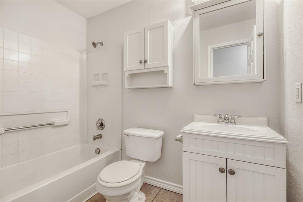 308 Butternut Drive Fate, TX 75087 - Photo 18 of 21 a bathroom with a sink toilet vanity and tub