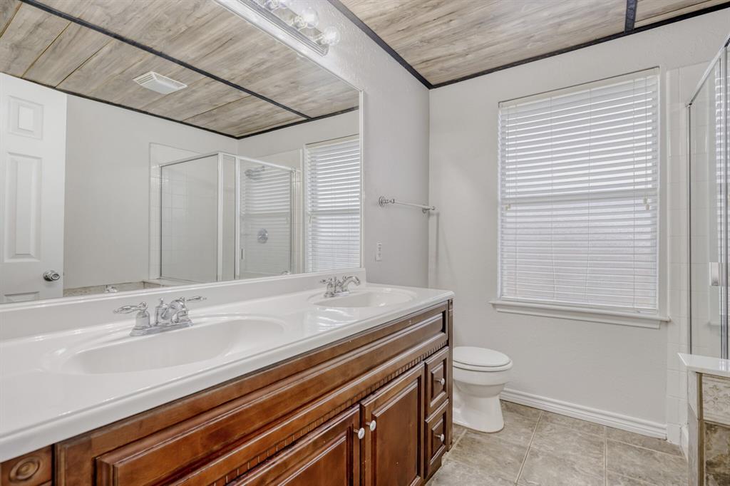308 Butternut Drive Fate, TX 75087 - Photo 19 of 21 a bathroom with a granite countertop sink toilet and shower