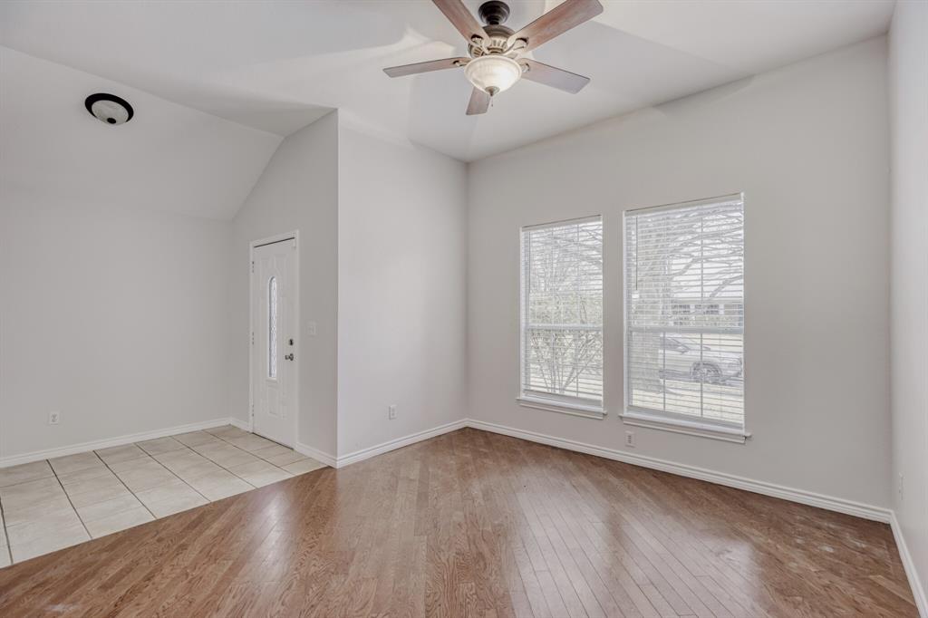 308 Butternut Drive Fate, TX 75087 - Photo 6 of 21 a view of an empty room with wooden floor and a window