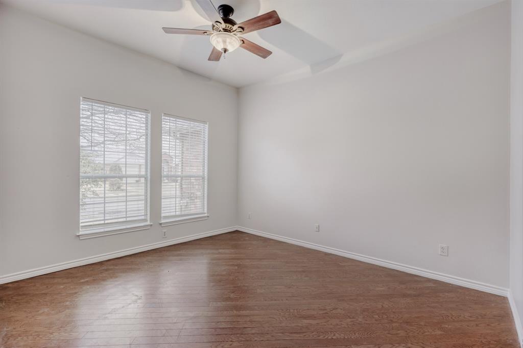308 Butternut Drive Fate, TX 75087 - Photo 7 of 21 an empty room with wooden floor fan and windows