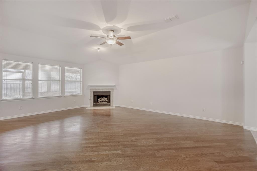 308 Butternut Drive Fate, TX 75087 - Photo 8 of 21 a view of an empty room with a window and wooden floor
