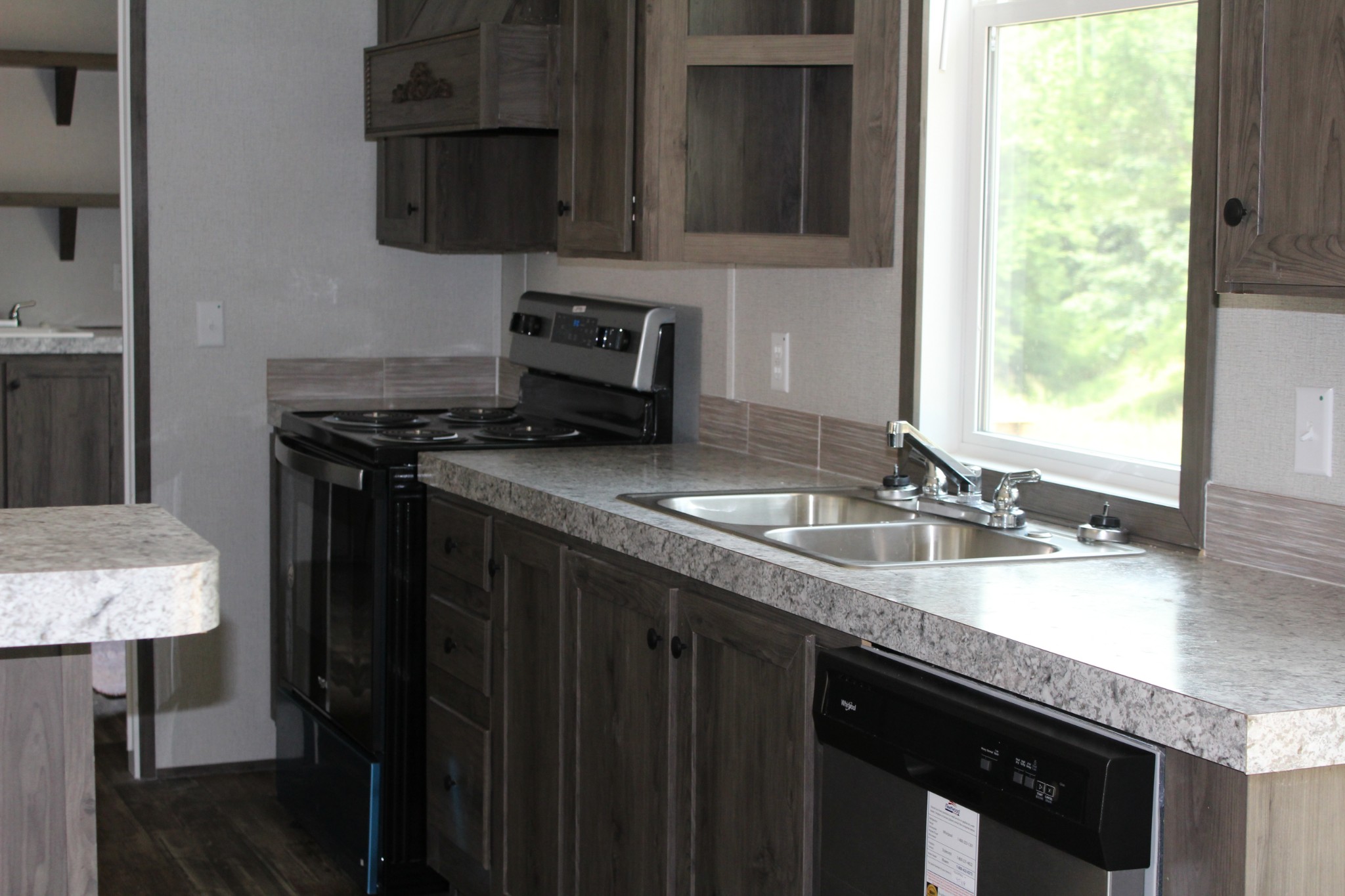 595 Days Road Lafayette, TN 37083 - Photo 19 of 21 a kitchen with granite countertop a sink a stove and a wooden cabinets