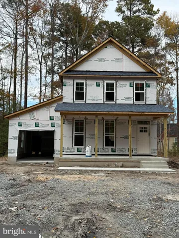 a view of a white house with large windows and a large tree with large windows