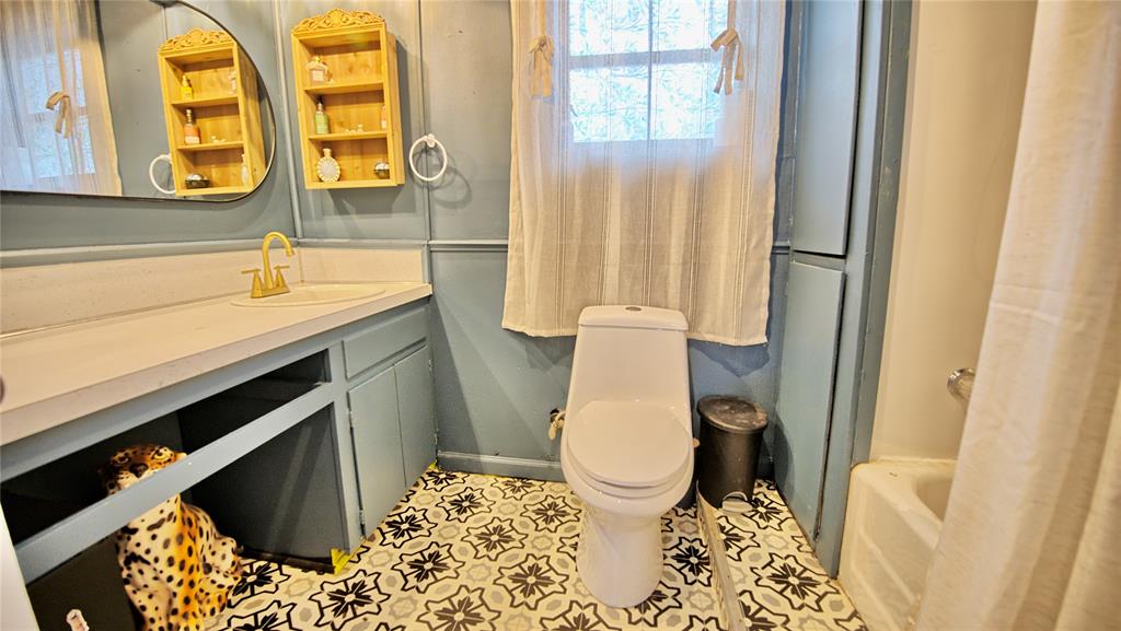 140 Elm Road Nocona, TX 76255 - Photo 13 of 26 a bathroom with a sink and a mirror