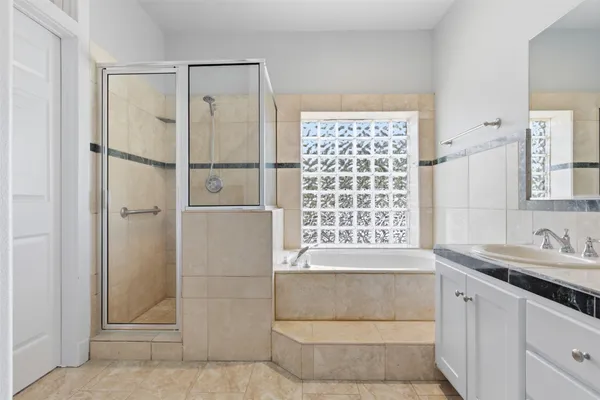 a bathroom with a shower and a sink