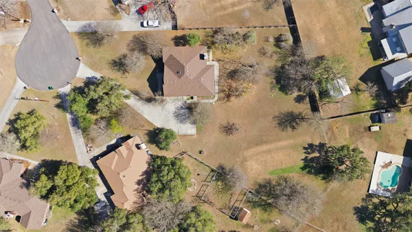 an aerial view of ocean and residential houses with outdoor space