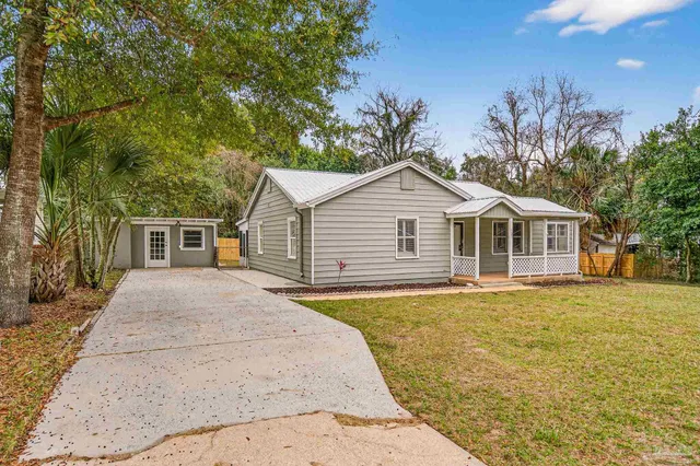 a front view of a house with a garden