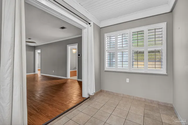 a view of an empty room with windows